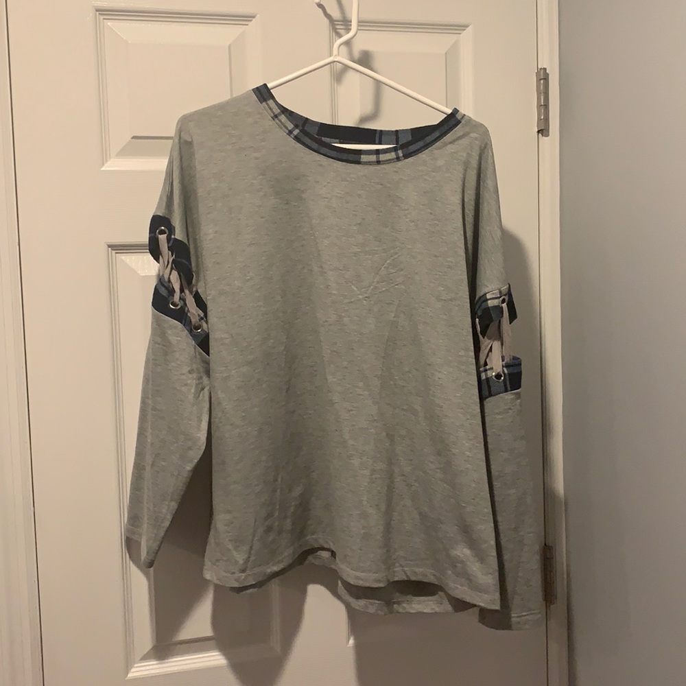 Grey long sleeve with blue checker arms and collar